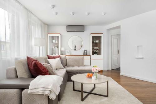 a living room with a couch and a table at Family Apartment with 3 Bedrooms & Air Conditioning in the Centre of Wrocław by Noclegi Renters in Wrocław