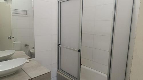 a bathroom with a shower with a toilet and a sink at FincaMora in Colonia del Sacramento