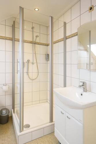 a bathroom with a shower and a sink at Gästehaus Marietta in Osann-Monzel