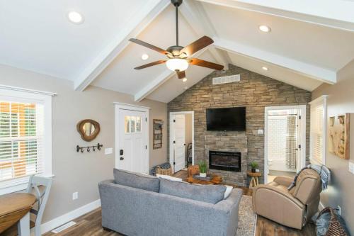 a living room with a ceiling fan and a fireplace at WiFi & Waterfront - Soul Sister Red River Gorge KY in Rogers
