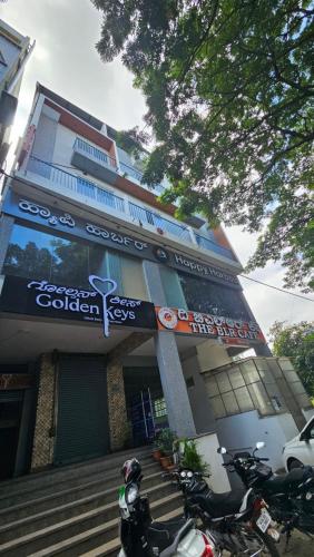 a building with motorcycles parked in front of it at Golden Keys Hotel Chikkabanavara in Bengaluru
