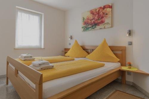 a bedroom with two beds with towels on them at Gästehaus Marietta in Osann-Monzel