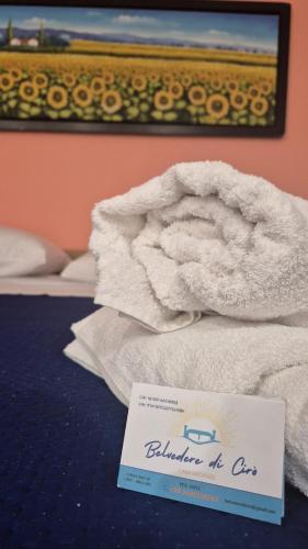 a pile of towels on a table with a sign at Belvedere di Ciro' in Cirò