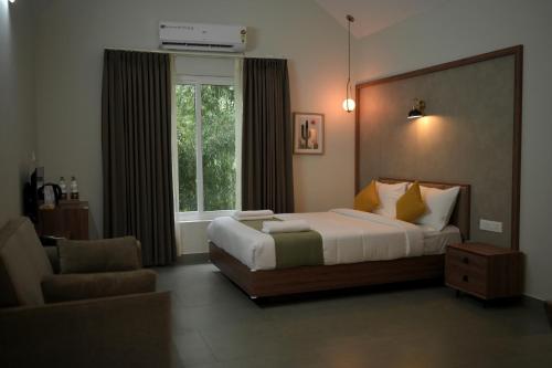 a bedroom with a large bed and a window at The village vista in Batheri