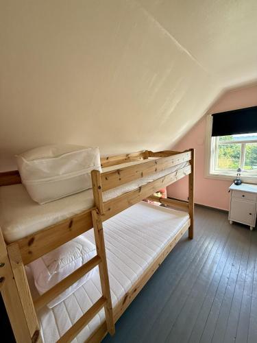 two bunk beds in a room with a window at Peaceful retreat in Lofoten in Sennesvik