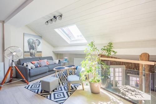 a living room with a couch and a fireplace at Le 3 de Coeur Annecy in Annecy