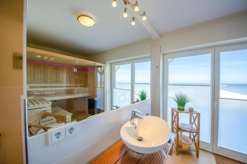 a bathroom with a sink and a view of the ocean at Ferienhaus Auf der Ostsee in Kappeln