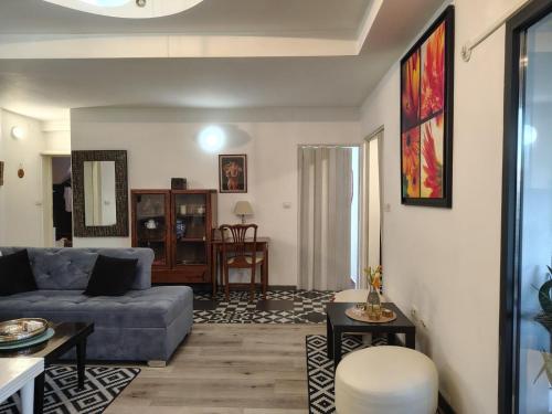 a living room with a couch and a table at Katata Apartment Spacious House Floor with Terraces, 3 Bedrooms, Parking,Wi-Fi in Podgorica