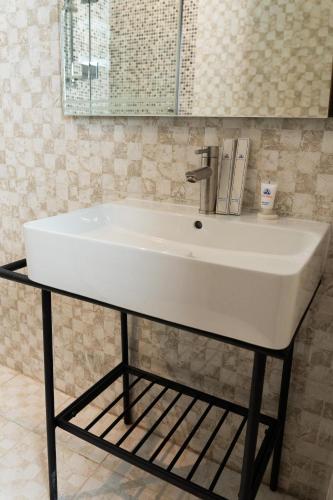 a white sink on a stand in a bathroom at Sara Palace Apartments- family only in Kuwait