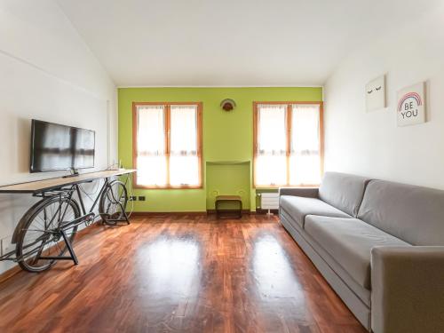 a living room with a couch and a tv at Corso San Gottardo - Darsena Flat in Milan