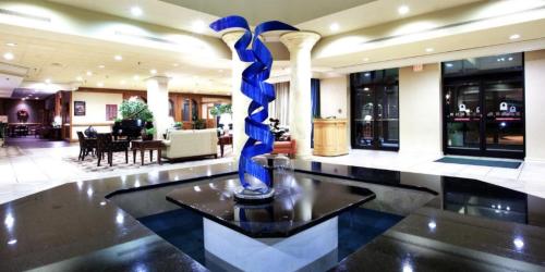 a blue vase sitting on a table in a lobby at Lynchburg Grand Essential by IHG in Lynchburg