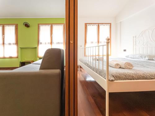a bedroom with a bed and a crib at Corso San Gottardo - Darsena Flat in Milan