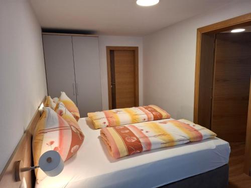a bedroom with a bed with two pillows on it at WG Appartment in Kleinarl