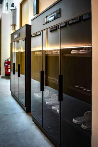a row of glass display cases in a store at GUSTI Backpackers Capsule Hostel Singapore in Singapore