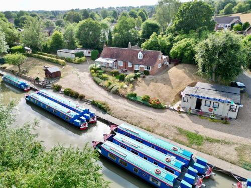 a group of buses are parked in the water at Waterside Cottage - Sleeps 11 on Grand Union Canal in Linslade