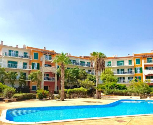 an apartment complex with a swimming pool and palm trees at BEACH HOUSE - Walkable to Beach - Wi-Fi Included in Santa Maria