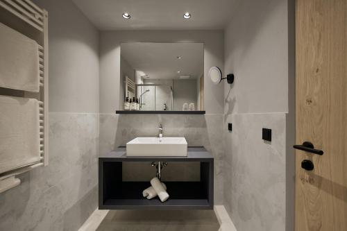 a bathroom with a sink and a mirror at Berghotel in Racines