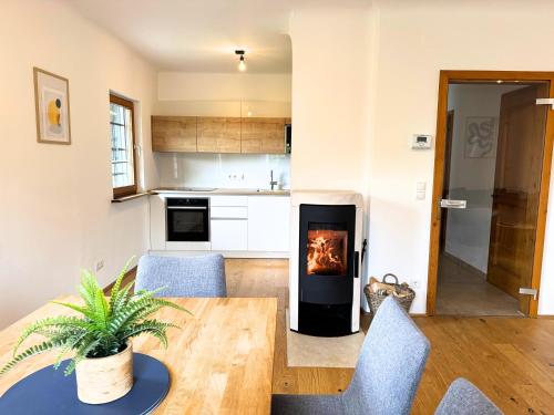 a living room with a table and a fireplace at Ferienhaus Panorama - Gamlitz in Gamlitz