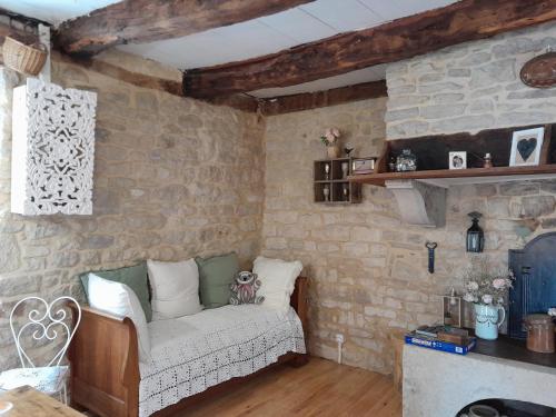 sala de estar con sofá en una pared de ladrillo en La Petite Authentique, en Gaillac-dʼAveyron