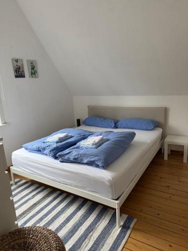 a bed with blue pillows on it in a bedroom at Fewo Urlaubsspaß in Walsrode