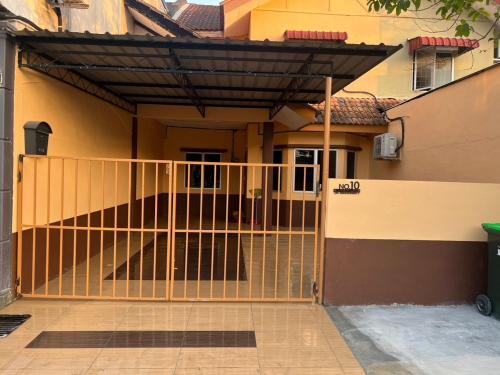 a gate in front of a house at Amani guesthouse in Padang Besar
