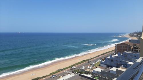 an aerial view of a beach with buildings and the ocean at Stunning Luxury Penthouse at 30 Degrees, Umdloti Beachfront in Umdloti