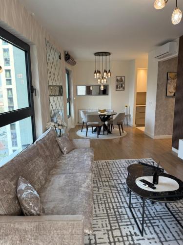 a living room with a couch and a table at Belgrade Waterfront Sky & River View Residences in Belgrade