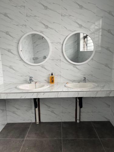 a bathroom with two sinks and two mirrors at Musgrave Escape in Durban