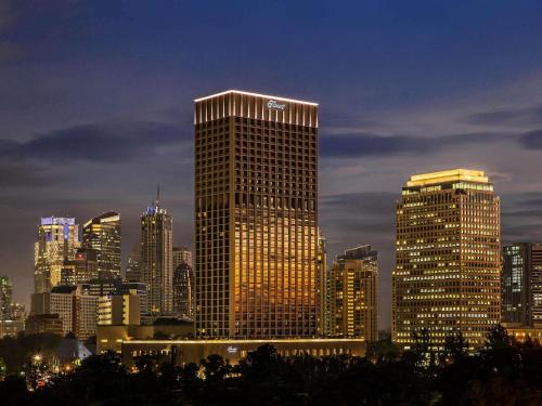 a city skyline with a lot of tall buildings at Fairmont Jakarta in Jakarta
