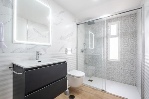 a bathroom with a shower and a toilet and a sink at Niza 11-A Apartment Levante Beach in Benidorm