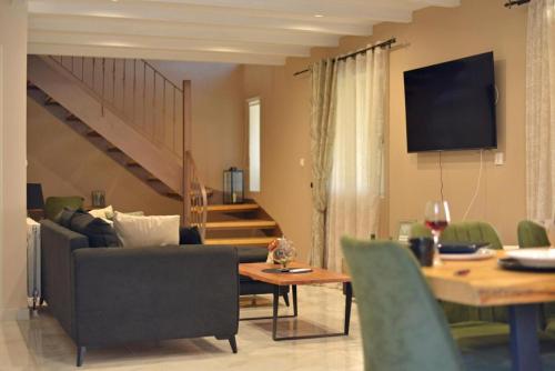 a living room with a couch and a table at Casa Sorgente in Ágioi Doúloi