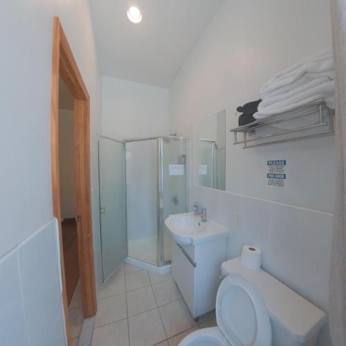 a bathroom with a toilet and a sink at U.S. Pacific Hotel in New York