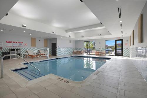a large swimming pool in a building with a pool at Holiday Inn - Chicago - Tinley Park by IHG in Tinley Park