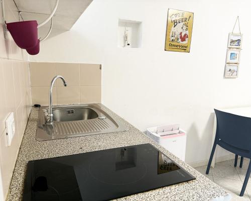 a kitchen with a sink and a counter top at Alture di Como-splendido appartamento in Como
