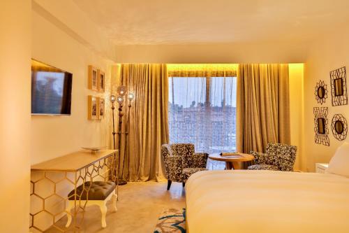 a hotel room with a bed and a desk and a window at 2Ciels Boutique Hôtel in Marrakesh