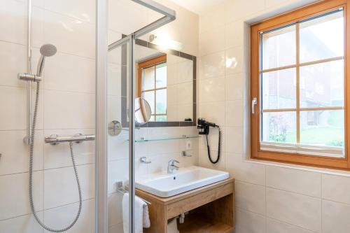 a bathroom with a sink and a shower at Landal Brandnertal in Bürserberg