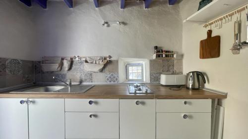 a kitchen with a sink and a counter top at Casa Cueva Solara, peace and nature in Cabo de Gata in Níjar