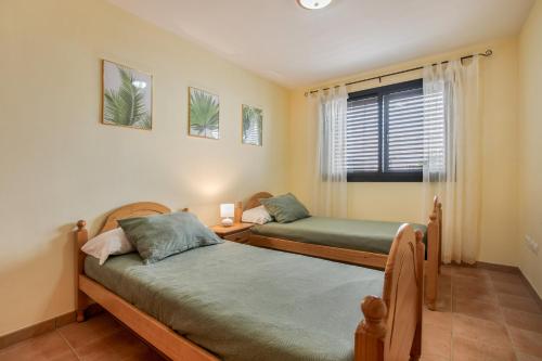 Ένα ή περισσότερα κρεβάτια σε δωμάτιο στο Palm Serenity