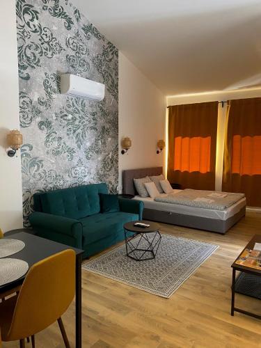 a living room with a couch and a bed at Riverside Apartment in Makó