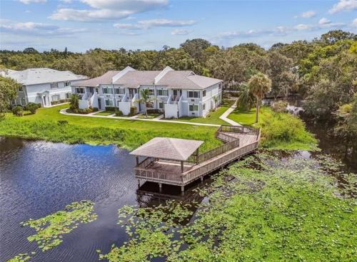 an aerial view of a house on the water with a dock at Studio retreat by the river in Tampa