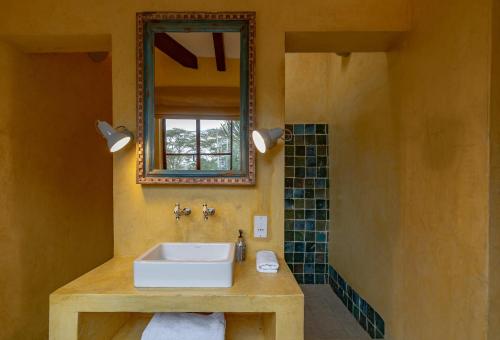a bathroom with a sink and a mirror at Yellow House 3-bedroom Villa In Nature in Naivasha