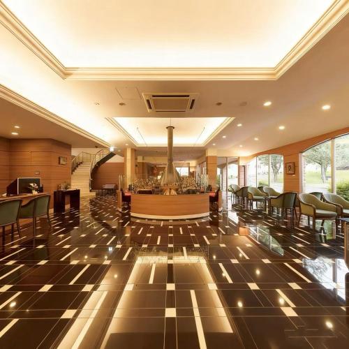 a lobby with chairs and a bar in a building at Wyndham Garden Nagaizumi in Numazu
