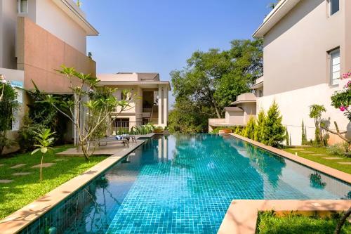 an image of a swimming pool in a villa at Da Alohas Hibiscus Oasis Pool Facing Candolim in Betim
