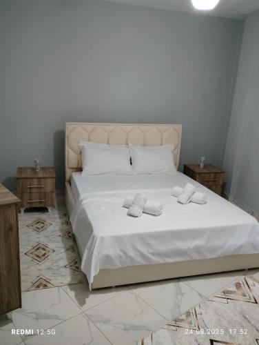 a bedroom with a bed with two towels on it at Vila Marini in Lin