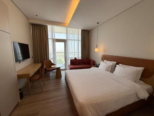 a hotel room with a large bed and a desk at Luxery Hotel Apartment l Novotel Residence l JVT in Dubai