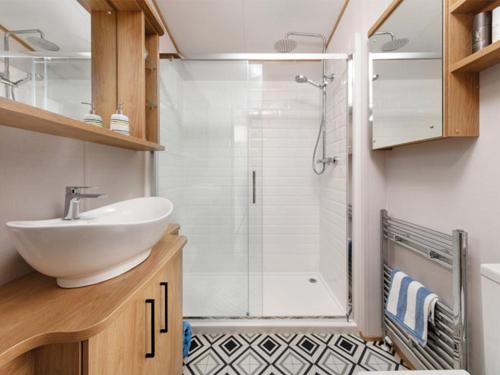 a bathroom with a sink and a shower at Wilksworth Caravan Park in Wimborne Minster