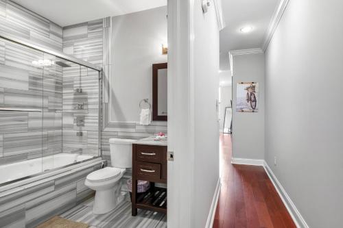 a bathroom with a tub and a toilet and a sink at XL Studio - Modern Studio with Rooftop Pool in Philadelphia