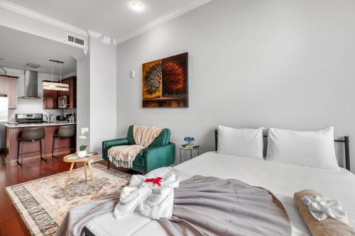 a bedroom with a large bed and a kitchen at XL Studio - Modern Studio with Rooftop Pool in Philadelphia