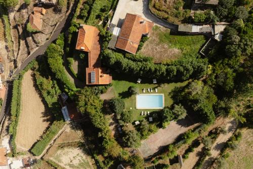 an overhead view of a house with a yard at Quinta do Pomarinho - by RowdHouses in Arouca