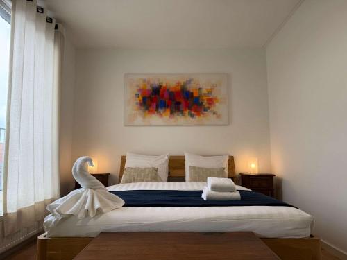 a bedroom with a bed with a swan on it at Spacious Family Home and Free Parking in Eindhoven in Eindhoven